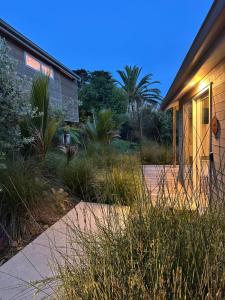 a house with a walkway next to a house at One O One Cabins, Waiheke Island in Oneroa +8 photos