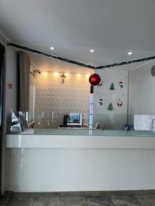 a store counter with christmas decorations on the wall at Residencial Neo 1 in Maceió +8 photos