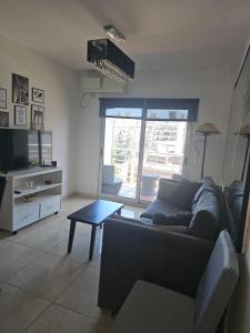 a living room with a couch and a table at PALERMO APART 1 in Buenos Aires