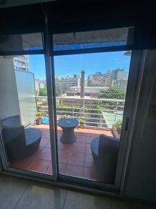 a view of a balcony with a table and chairs at PALERMO APART 1 in Buenos Aires