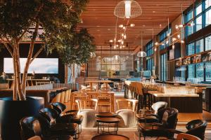 a restaurant with chairs and tables and a bar at Limelight Boulder in Boulder