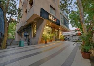 a building with a sign on the side of it at Townhouse Oak Pune Railway Station Formerly Kapil Residency in Pune