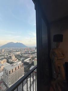 Una estatua de un hombre con sombrero de copa en un balcón. en BARRIO W -The best place to rest in downtown MTY, en Monterrey