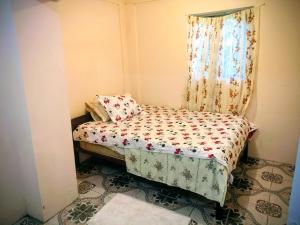 a small bed in a room with a window at BtC Apartments St Paul's in Saint Paulʼs