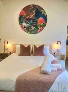 欧尼罗亚One O One Cabins, Waiheke Island的卧室里有一张白色的大床，床边还有两盏灯 更多5张照片