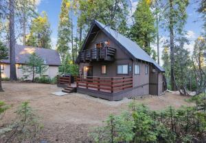 a black house with a gambrel roof at Boss's Cabin - Boss-level views, zero stress! in Shaver Lake