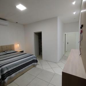 Ένα ή περισσότερα κρεβάτια σε δωμάτιο στο AP Morada das Palmeiras