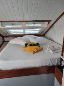 a bed in the middle of a room in a boat at catamaran nautilodge in Sainte-Anne