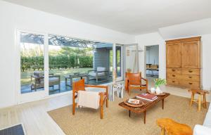 a living room with a table and chairs at Cowhill Cottage by Rove Home with Pool & Lounge in Wainscott +31 photos