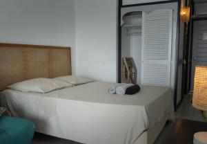 a bedroom with a bed with two towels on it at Gap Caraïbes in Le Diamant