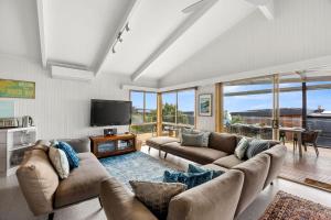 a living room with two couches and a television at Boston Beach House - BYO Linen in Lorne