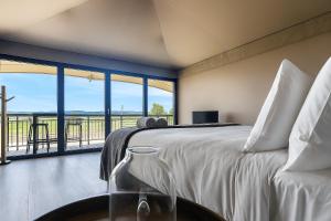 a bedroom with a bed and a large window at Apollo Bay Recreation Reserve in Apollo Bay