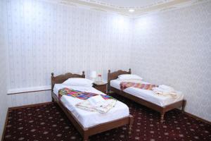 Voodi või voodid majutusasutuse Royal Garden toas