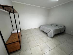 Giường trong phòng chung tại Espaço JD