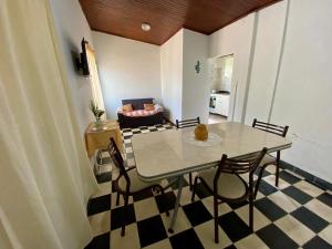 a dining table and chairs in a living room at Los Cardenales in San José