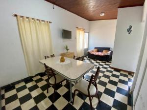 a living room with a table and chairs and a couch at Los Cardenales in San José
