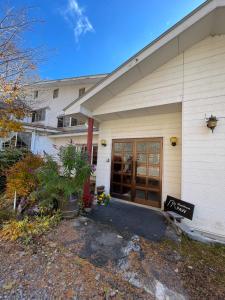 a building with a sign in front of it at Guesthouse PAW in Nagano