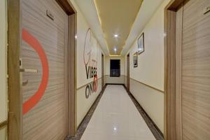 a corridor of a hallway with graffiti on the walls at Townhouse Oak Pune Railway Station Formerly Kapil Residency in Pune +17 photos