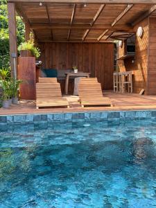 a patio with chairs and a swimming pool at Chill lodge in Sainte-Luce