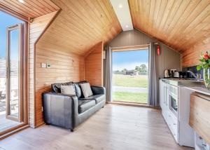 a living room with a couch in a tiny house at South View Retreat in Carlton