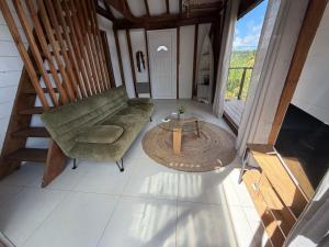 an overhead view of a living room with a couch and a table at Chill lodge in Sainte-Luce