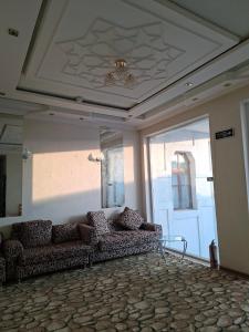 a living room with a couch and a ceiling at Royal garden in Bukhara