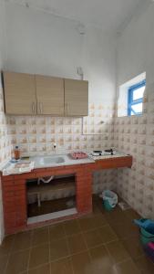 a kitchen with a brick counter in a room at Beira Mar Residencial in Capão da Canoa