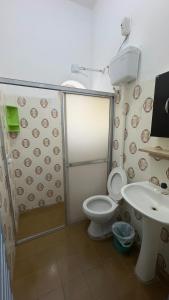a bathroom with a shower and a toilet and a sink at Beira Mar Residencial in Capão da Canoa +116 photos