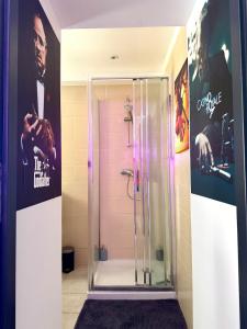 a shower in a bathroom with posters on the wall at Cinéma Room - La Valette - Toulon - Hyères in La Valette-du-Var +26 photos