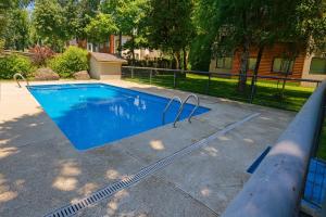 a blue swimming pool with a hose around it at Refugio del volcán in Pucón +4 photos