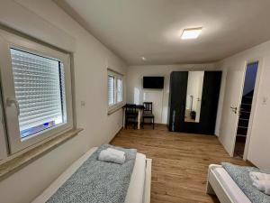 a bedroom with two beds and a large window at 92 City Rooms in Koblenz +13 photos