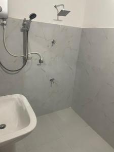 a bathroom with a shower and a sink at Penthouse Bandarawela in Bandarawela