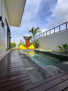 a swimming pool in the middle of a house at Aloka Villa -Stylish 2 bedroom villa in the heart of Seseh in Munggu
