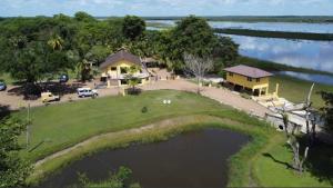 an aerial view of a house next to a lake at CROOКED TREE LODGE Belize in Crooked Tree