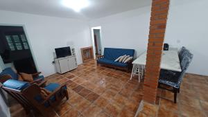 a living room with a couch and a table and chairs at Vida Mansa Apartamentos in Capão Novo