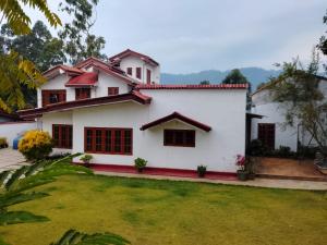 a house with a lawn in front of it at Penthouse Bandarawela in Bandarawela