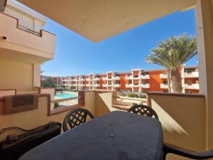 a table and chairs on the balcony of a apartment at T2 Djadsal Bloco Laranja Perto da Praia e Centro in Santa Maria
