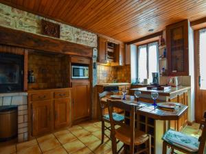 a kitchen with wooden cabinets and a wooden ceiling at Padirac Countryside Charm in Padirac