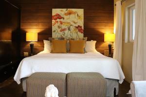 une chambre avec un lit blanc et un tableau de fleurs dans l'établissement Suite Romantica Valle AC WiFi Alberca y Asador, à San Pablo