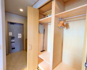 a room with a walk in closet and a door at The Global Tower in Niihama +74 photos