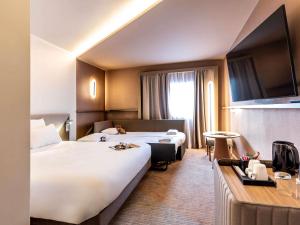 Ένα ή περισσότερα κρεβάτια σε δωμάτιο στο Novotel Paris Orly Rungis Aéroport