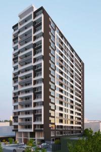 a rendering of a tall apartment building at Central space in Concepción