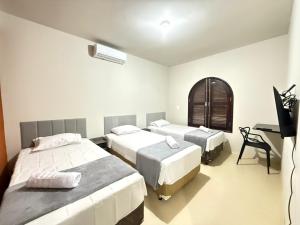 Ένα ή περισσότερα κρεβάτια σε δωμάτιο στο Pousada Dona Lidia Express