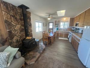 a kitchen and living room with a refrigerator and a table at Peaceful Big Bear Cabin in Baldwin Lake