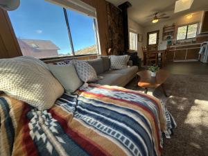 a living room with a couch and a large window at Peaceful Big Bear Cabin in Baldwin Lake +30 photos