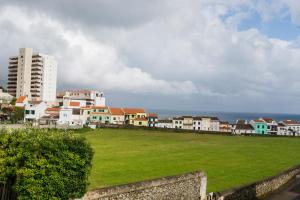 a city with buildings and a field of grass at Azor Beach Lodge in Ponta Delgada