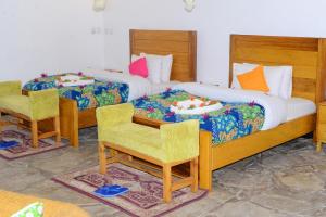 Ένα ή περισσότερα κρεβάτια σε δωμάτιο στο Le Bambou Gorilla Lodge