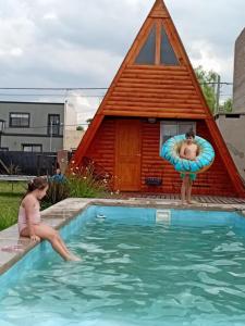two children playing in a pool in a house at La casita de las flores in Roldán