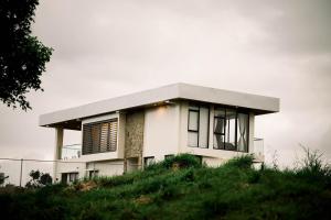 a white house on top of a hill at Villa 360 in Calaca