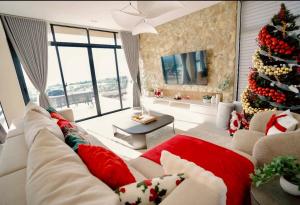 a living room with a christmas tree and a couch at Villa 360 in Calaca +44 photos